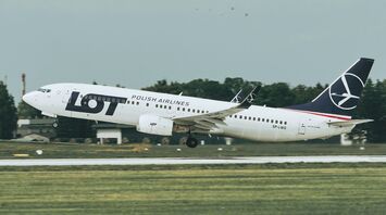 LOT Polish Airlines aircraft taking off from runway