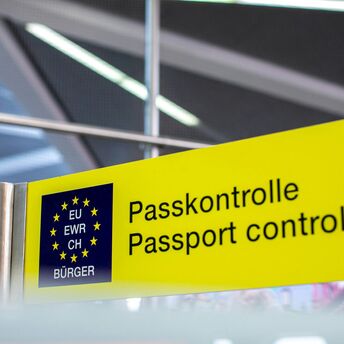 Yellow airport sign showing passport control for EU citizens
