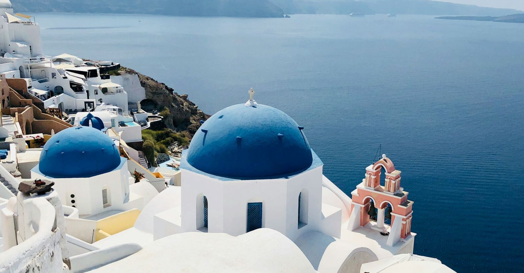 White buildings and blue-domed church overlooking Santorini caldera