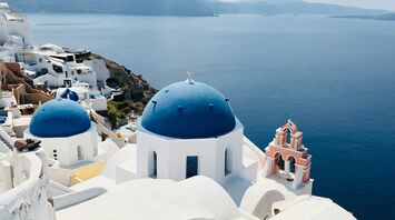 White buildings and blue-domed church overlooking Santorini caldera