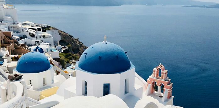 White buildings and blue-domed church overlooking Santorini caldera