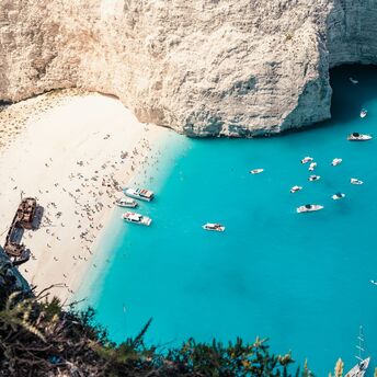 Zakynthos Navagio Beach with turquoise water and boats