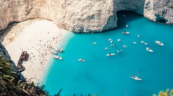 Zakynthos Navagio Beach with turquoise water and boats