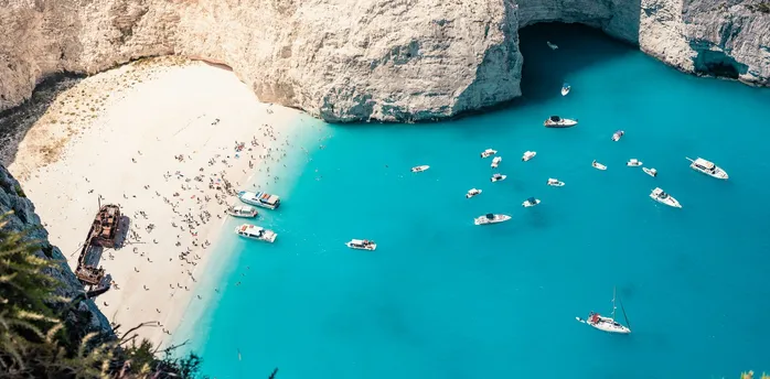 Zakynthos Navagio Beach with turquoise water and boats