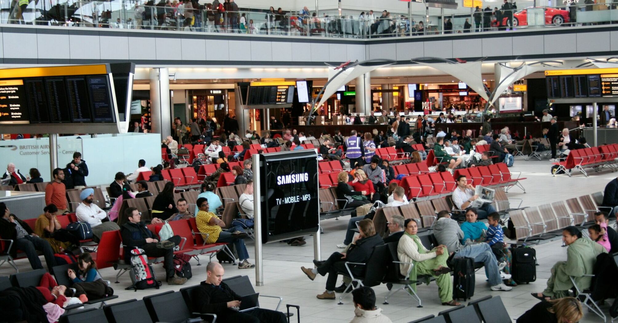 Crowded airport departure lounge with waiting passengers