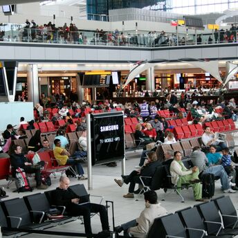 Crowded airport departure lounge with waiting passengers