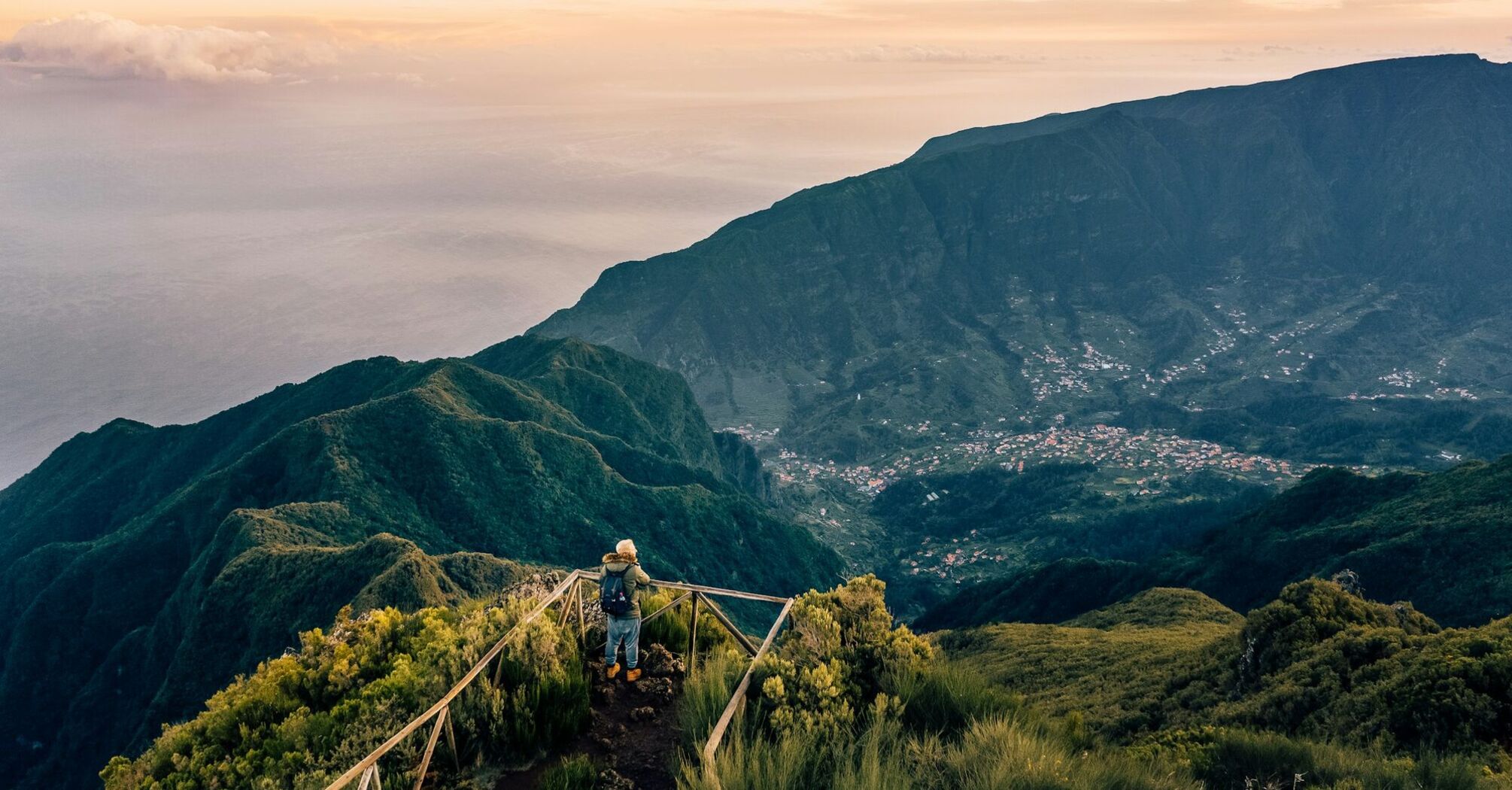 Hiker standing on viewpoint above Madeira mountain valley