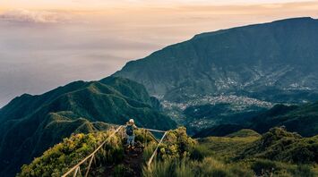 Hiker standing on viewpoint above Madeira mountain valley