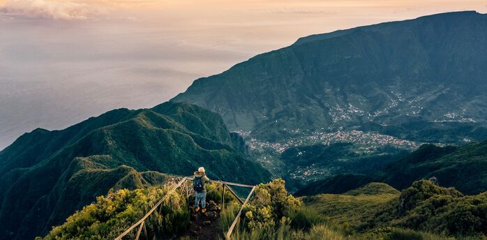 Hiker standing on viewpoint above Madeira mountain valley