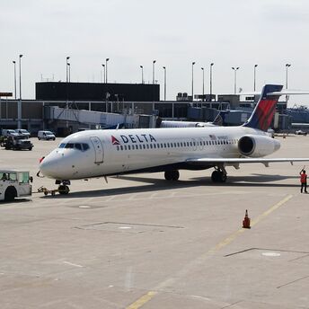 Delta Air Lines aircraft on airport apron near terminal