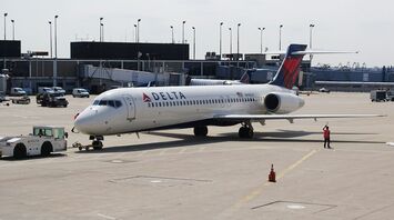 Delta Air Lines aircraft on airport apron near terminal