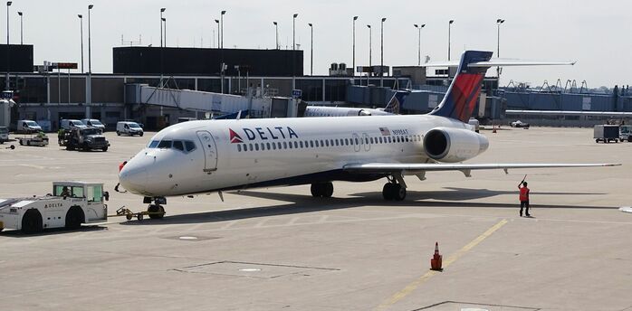 Delta Air Lines aircraft on airport apron near terminal