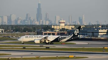 Air New Zealand Boeing 787-9 aircraft taxiing at airport with city skyline in background