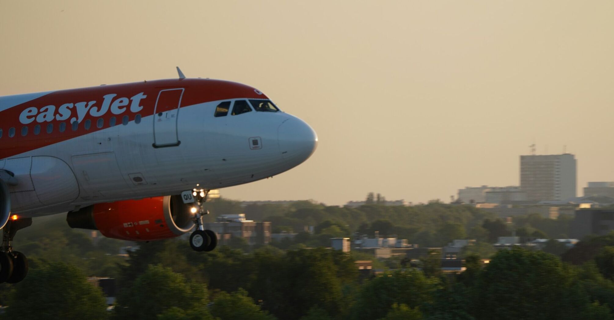 easyJet aircraft approaching runway at sunset