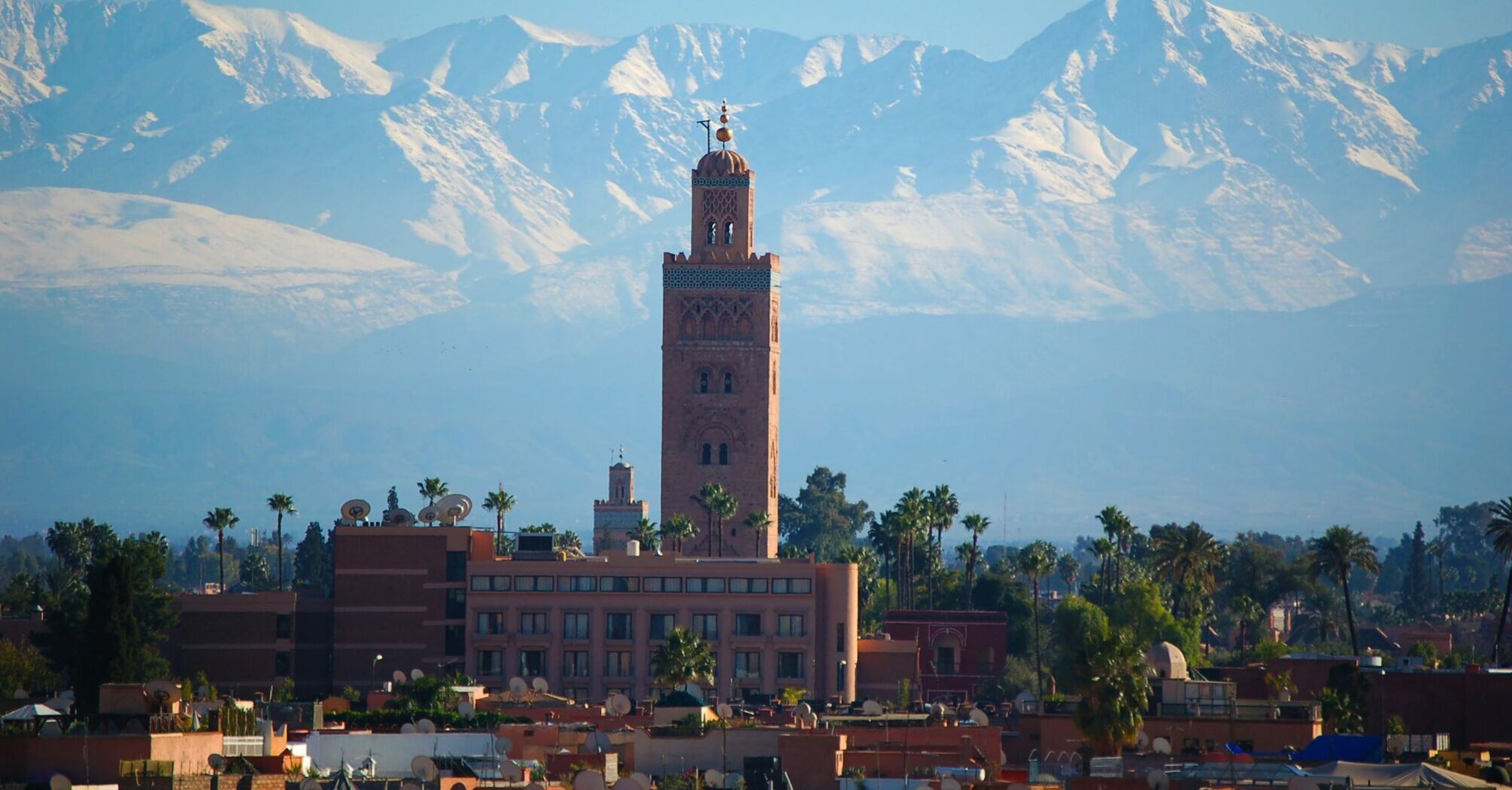 Koutoubia Mosque with Atlas Mountains in Marrakech