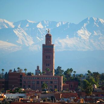 Koutoubia Mosque with Atlas Mountains in Marrakech