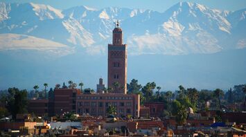 Koutoubia Mosque with Atlas Mountains in Marrakech