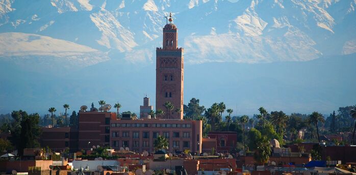 Koutoubia Mosque with Atlas Mountains in Marrakech