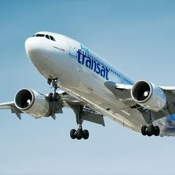 Air Transat aircraft in flight against clear sky