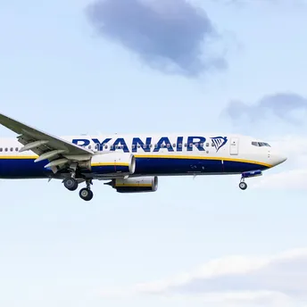 Ryanair aircraft in flight against blue sky