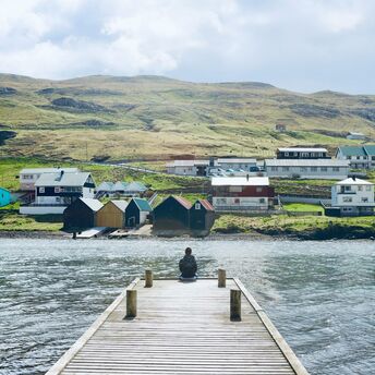 Qaqortoq coastal settlement with colourful houses and green hills by the fjord