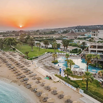 Beachfront resort with pools, sunbeds and sunset coastline view in Cyprus