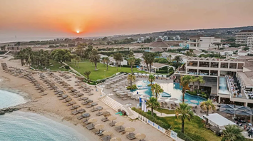 Beachfront resort with pools, sunbeds and sunset coastline view in Cyprus