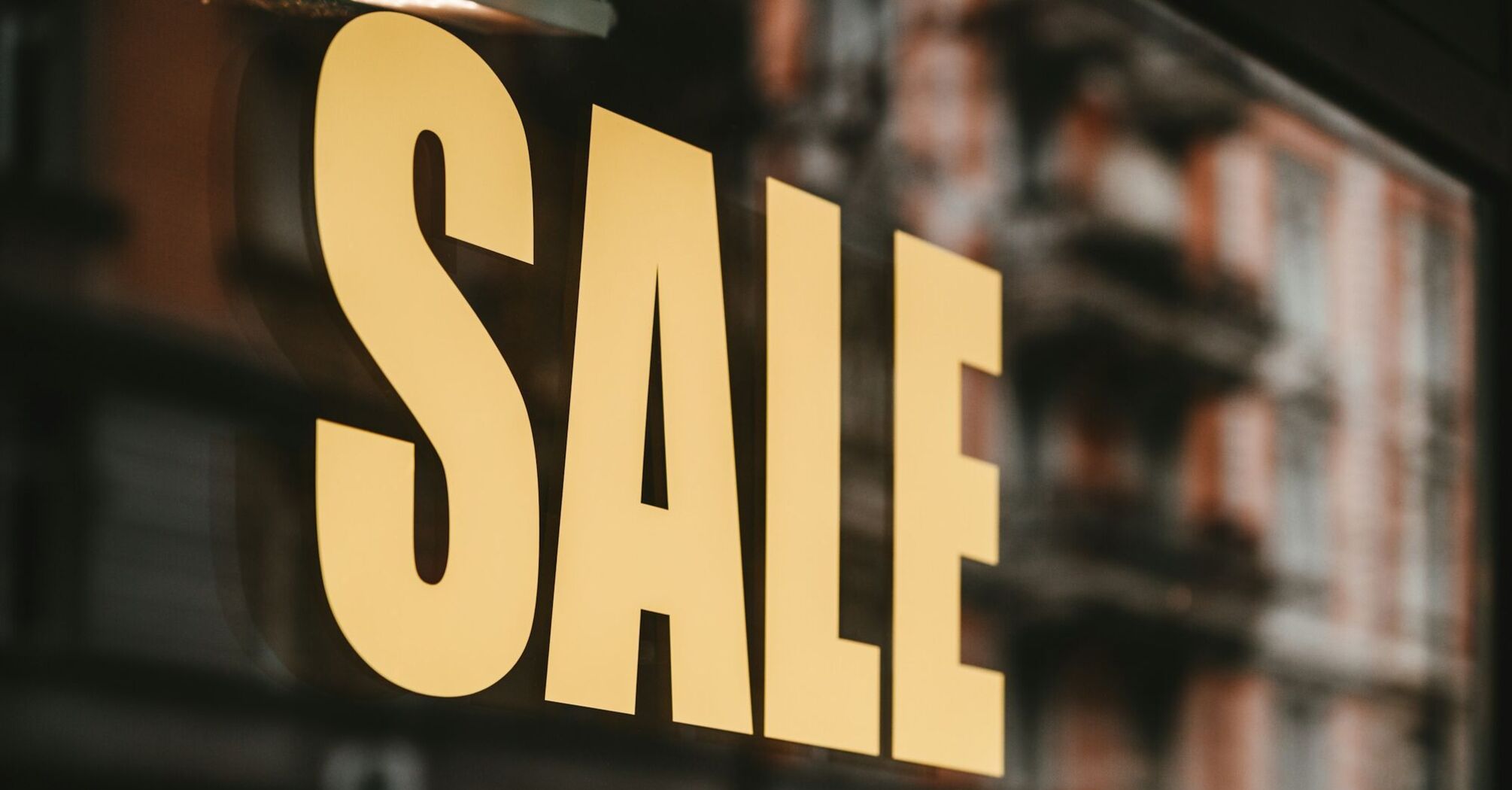 Shop window sign displaying large SALE text