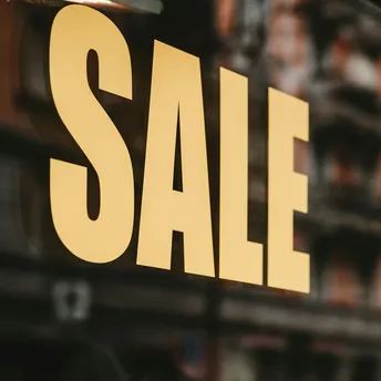Shop window sign displaying large SALE text