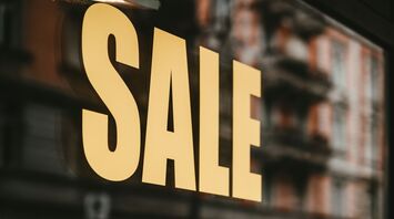 Shop window sign displaying large SALE text