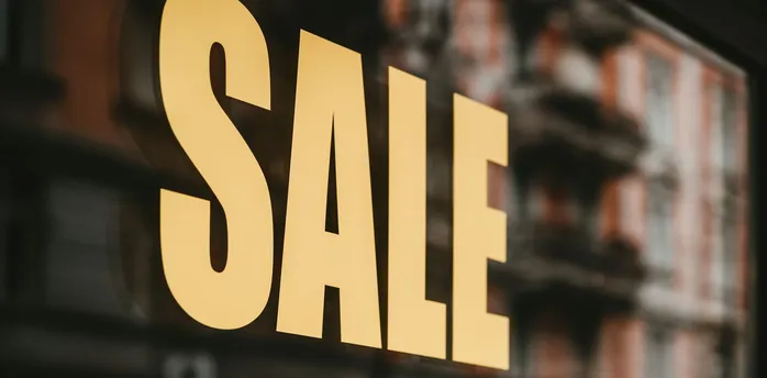 Shop window sign displaying large SALE text