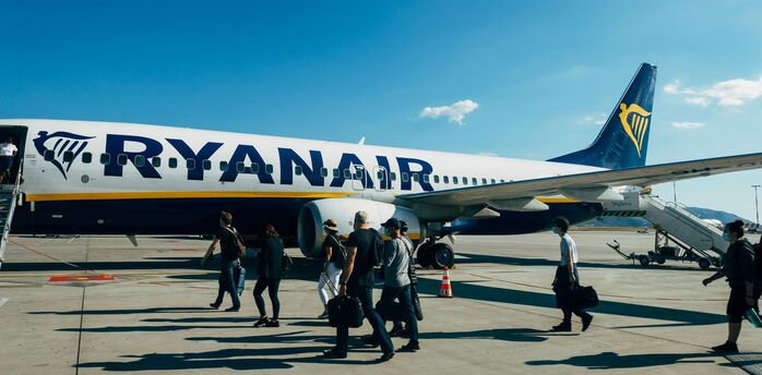 Ryanair aircraft on the runway with passengers boarding