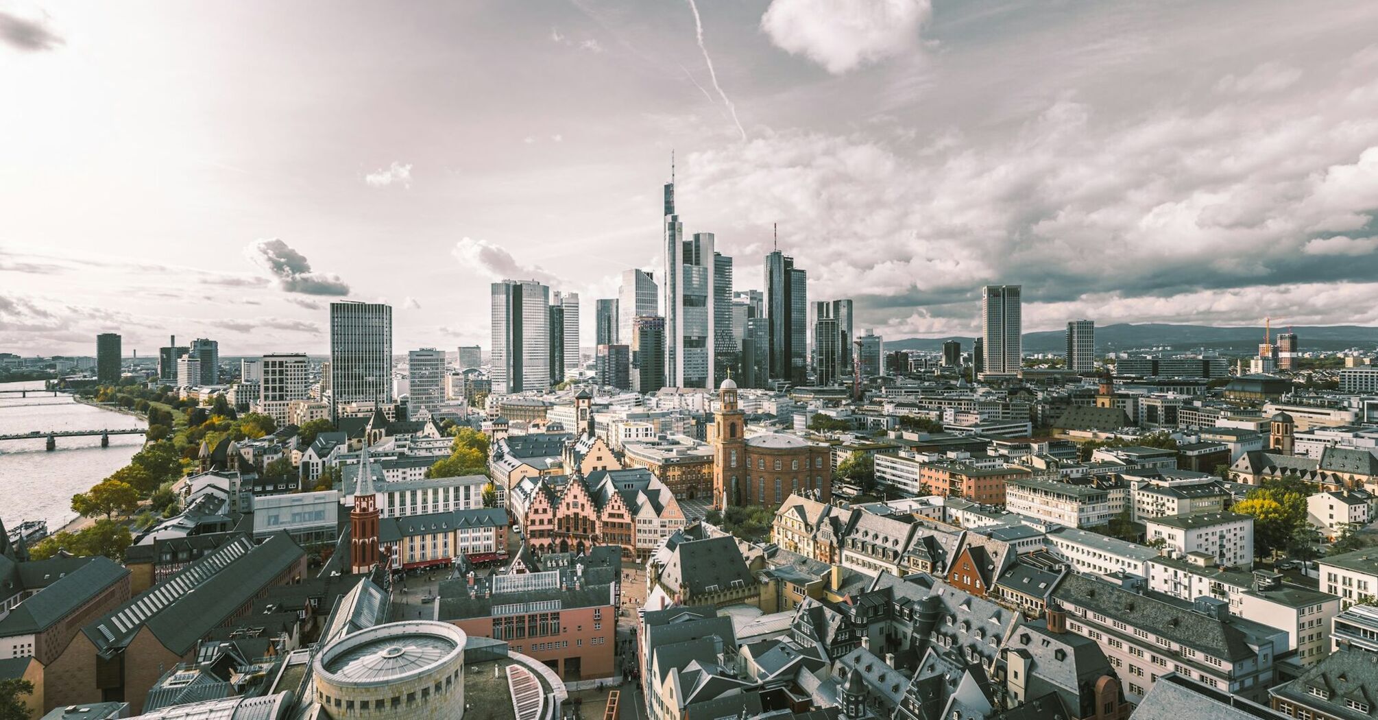 Frankfurt skyline with modern skyscrapers and historic buildings along the river