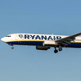 Ryanair passenger aircraft in flight against clear sky