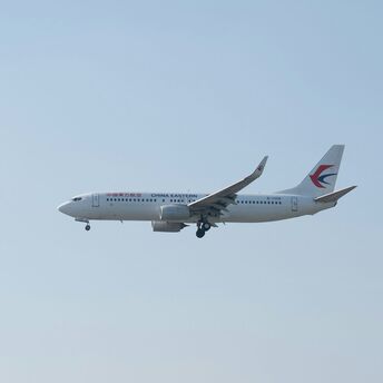 China Eastern Airlines aircraft in flight against clear sky