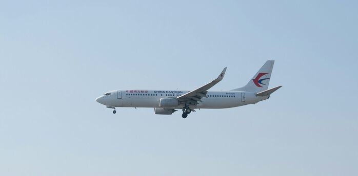 China Eastern Airlines aircraft in flight against clear sky