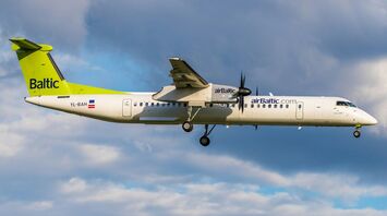 airBaltic aircraft in flight against cloudy sky