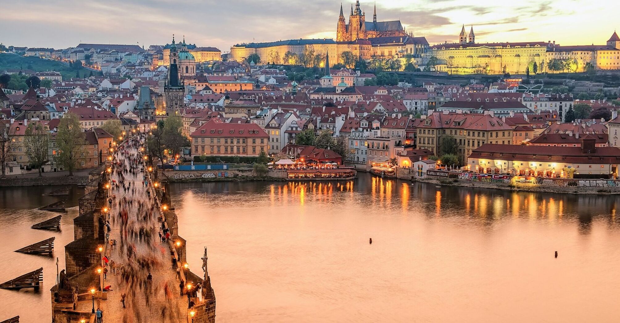 Prague skyline with Charles Bridge and castle at sunset
