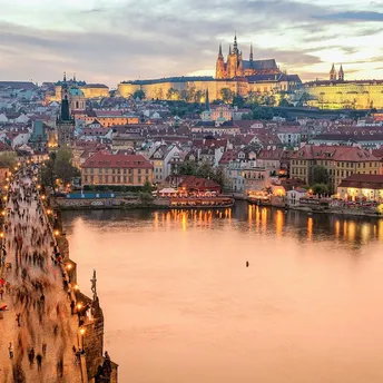 Prague skyline with Charles Bridge and castle at sunset
