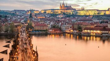 Prague skyline with Charles Bridge and castle at sunset