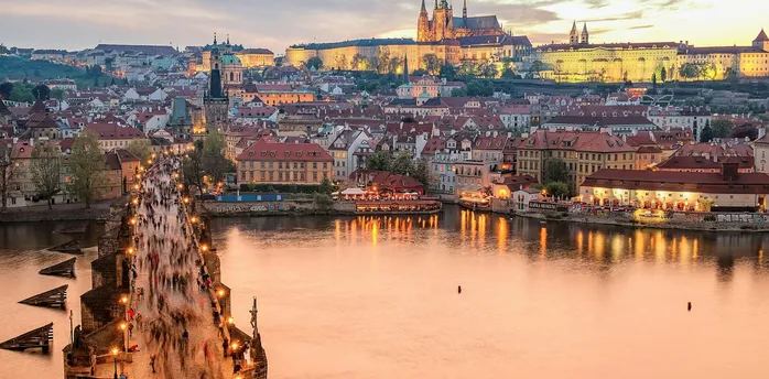 Prague skyline with Charles Bridge and castle at sunset