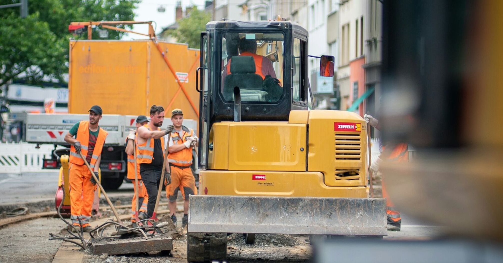 Roadworks on tram tracks with construction workers and machinery