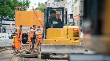Roadworks on tram tracks with construction workers and machinery