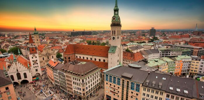 Munich city centre skyline with historic buildings and church towers at sunset