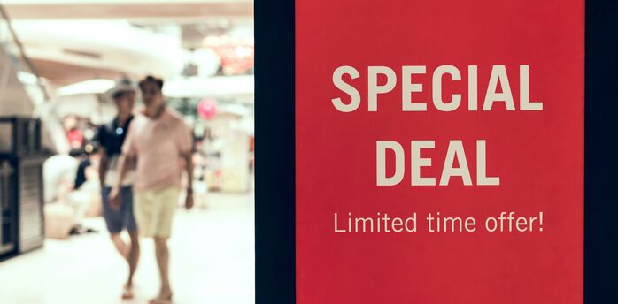 Red special deal sign inside shopping centre