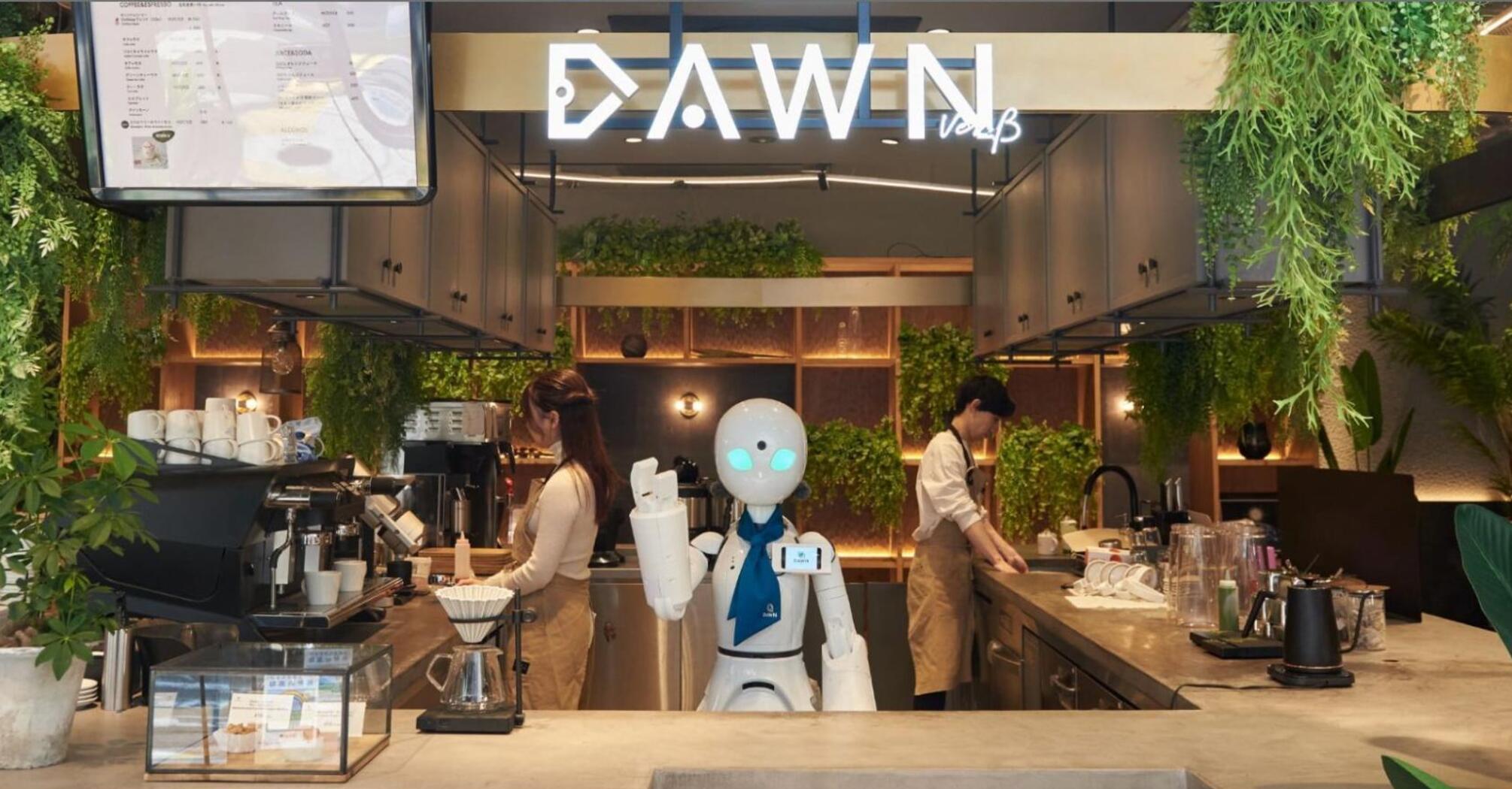 Robot assistant working behind a café counter with staff preparing drinks