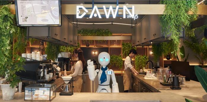 Robot assistant working behind a café counter with staff preparing drinks