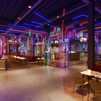 Neon-lit indoor entertainment venue with arcade and seating areas