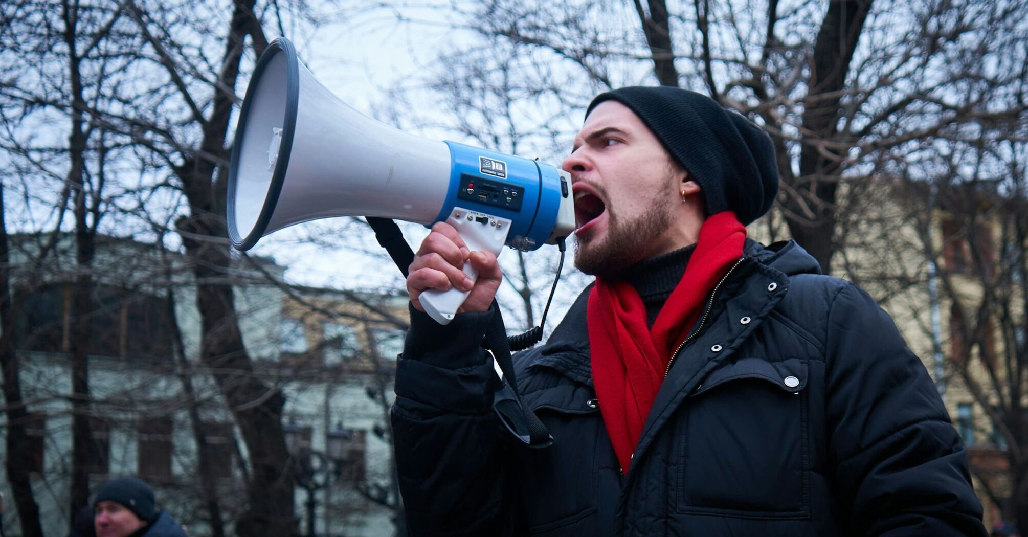 Man speaking through megaphone during protest