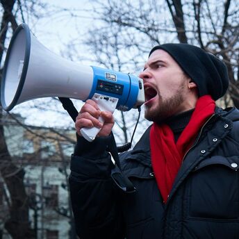Man speaking through megaphone during protest